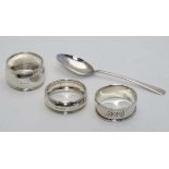 3 various Silver napkin rings together with a silver teaspoon. The teaspoon hallmarked  Birmingham