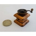 Needlework - A c.1900 novelty tape measure in the form of a miniature old coffee grinder. 1 1/2"