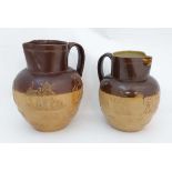 Two Doulton Lambeth ware Harvest Jugs decorated in relief with hunting scenes, windmills and