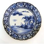 A Chinese blue and white porcelain dish decorated with a figure of a monk crossing the Xiang Xi to a