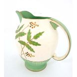 A Crown Devon Fieldings jug. In green and cream with leaves and berries design. Crown Devon mark