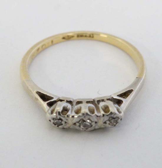 An 18ct gold ring set with three diamonds  CONDITION: Please Note -  we do not make reference to the