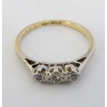 An 18ct gold ring set with three diamonds  CONDITION: Please Note -  we do not make reference to the