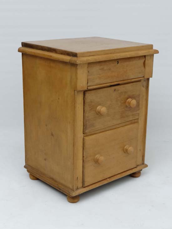 A 19thC Bedside cabinet / narrow pine chest comprising frieze drawer and 2 graduated long drawers
