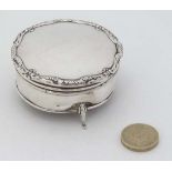 A silver ring box of circular form with hinged lid and 3 outswept feet. Hallmarked Birmingham 1931