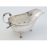 A silver sauce boat. Hallmarked Sheffield 11925 maker Walker & Hall. 6 1/2" long (114g) CONDITION: