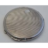 A silver powder compact with mirror and engine turned decoration. Hallmarked 1948 maker Crisford &