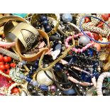 A large quantity of assorted costume jewellery including necklaces, bracelets etc  CONDITION: Please