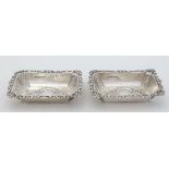 A pair of Victorian HM silver small dishes of rectangular form with embossed decoration Birmingham