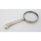 A silver handled magnifying glass 5" long  CONDITION: Please Note -  we do not make reference to the