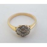 A gold ring set with 7 diamonds in a daisy setting CONDITION: Please Note -  we do not make