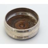 A silver bottle coaster with turned wooden base. Hallmarked London 1991 maker John Bull Ltd 3 3/4"