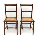 A pair of stained beech caned seated bedroom chairs. each standing 33" high  CONDITION: Please