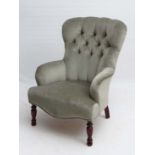 A Contemporary upholstered button back low armchair with turned front legs 37" high  CONDITION: