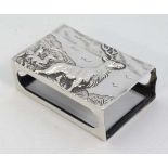 A silver match box cover with embossed image to top of stag and hinds in a moorland landscape.