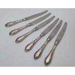 A set of 6 table knives with Continental .800 silver handles with floral and foliate decoration 8