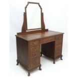 Maple & Co Ltd London & Paris : An oak cross banded dressing table comprising one drawer flanked