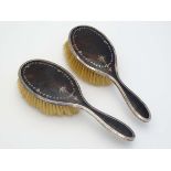 A pair of silver brushes with tortoiseshell and piquet work detail. Hallmarked Birmingham  1929