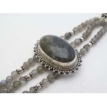 A .925 silver bracelet set with central Labradorite cabochon flanked by labradorite beads