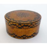 A Georgian circular lidded box with lacquered and faux straw work gilt and green detail.   3 1/2"