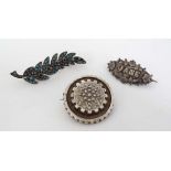 A silver brooch hallmarked Birmingham 1902  together with 2 white metal brooches one set with