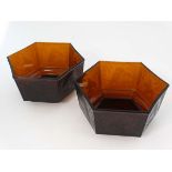 A unusual pair of Art Deco dark amber moulded glass hexagonal  formed jardineres decorated with