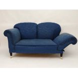 An Edwardian twin hump back drop end sofa with turned legs brass and porcelain castors and blue