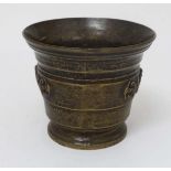 An 18thC seamed bronze mortar with relief decoration to central band. 4 1/2" high x 5 3/8" diameter