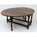 A bespoke 17thC style oak oval gate leg  table with twin baluster turned supports 56 1/2" wide x