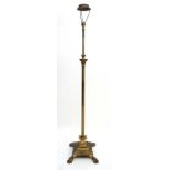 An early 20thC brass standard lamp of telescopic form with Corinthian column top, reeded column