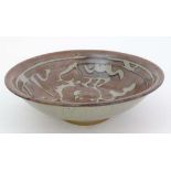 A Studio Pottery '' Slip Ware '' bowl . With brown glaze and mottled grey slip decoration.