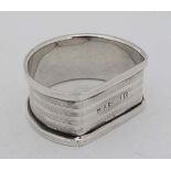 A silver napkin ring of shaped form with engine turned decoration. Hallmarked Birmingham 1930