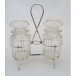 An early 20thC silver plate pickle cruet, the silver plate stand with loop handle and 2 pickle /