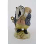 A Beswick Beatrix Potter figure of '' Tommy Brock '' with gold oval back stamp. 3 1/2'' high