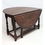 A c.1900 oak oval gate leg table with baluster turned supports 48" wide  CONDITION: Please Note -