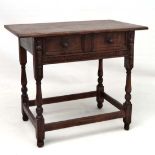 A 20thC oak side table with frieze drawer sliding on side hangers with carving a applied