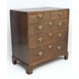 An 18thC oak caddy top chest of drawers comprising 2 short over 3 graduated long drawers standing on