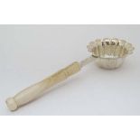 A silver plate  tea strainer with lobed flared bowl with pierced decoration and turned bone