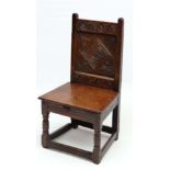 A 17thC carved oak solid seat single chair with panel back . 33" high x 17 3/4" wide x 15" deep