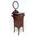A late 19thC walnut Gentleman's washstand with adjustable height circular shaving mirror, twin towel