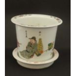 A Chinese pot together with  stand. The pot hand decorated in Famille Rose colours with Oriental