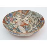 A large Japanese Kutani bowl . Decorated with scenes of oriental figures and birds . Together with