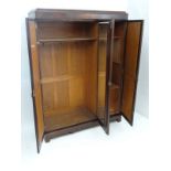 Early 20thC mahogany triple wardrobe, the right hand door opening to reveal  3 linen slides and