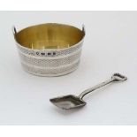 A Victorian silver salt in the form of a shallow two handled pail with banded decoration and
