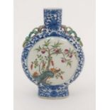 A Chinese Moon flask. Having lizard moulded handles. Painted in blue with lotus scrolls and the