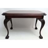 A c.1900 mahogany centre table with carved knees, ball and claw cabriole legs and feet and stepped