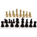 A  wooden chess set with painted blacks. Housed in a two-sectional box. The Kings 2 3/4'' high.