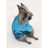 A 20thC novelty claret jug in the form of a squirrel eating a nut, having a turquoise glass body