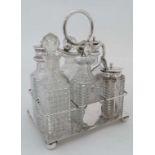 An early 20thC silver plate cruet stand with four squat bun feet and loop handle and 6 glass cruet