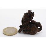 A carved hardwood netsuke in the form of a Qilin. 1 3/4" long  CONDITION: Please Note -  we do not